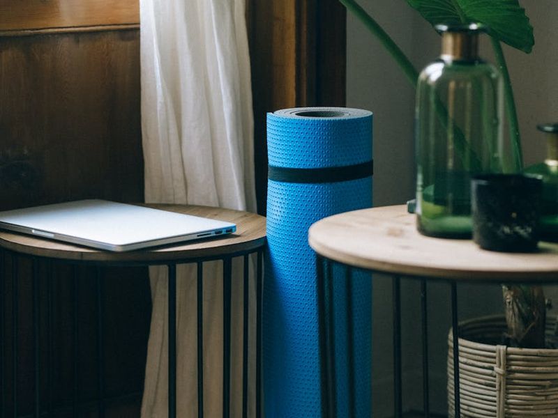 A bright, airy room with a yoga mat rolled out on the floor.